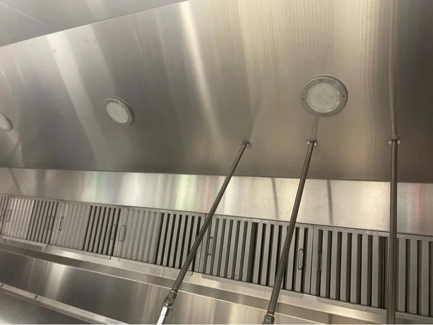 Clean baffle filters and hood lights in a stainless commercial hood