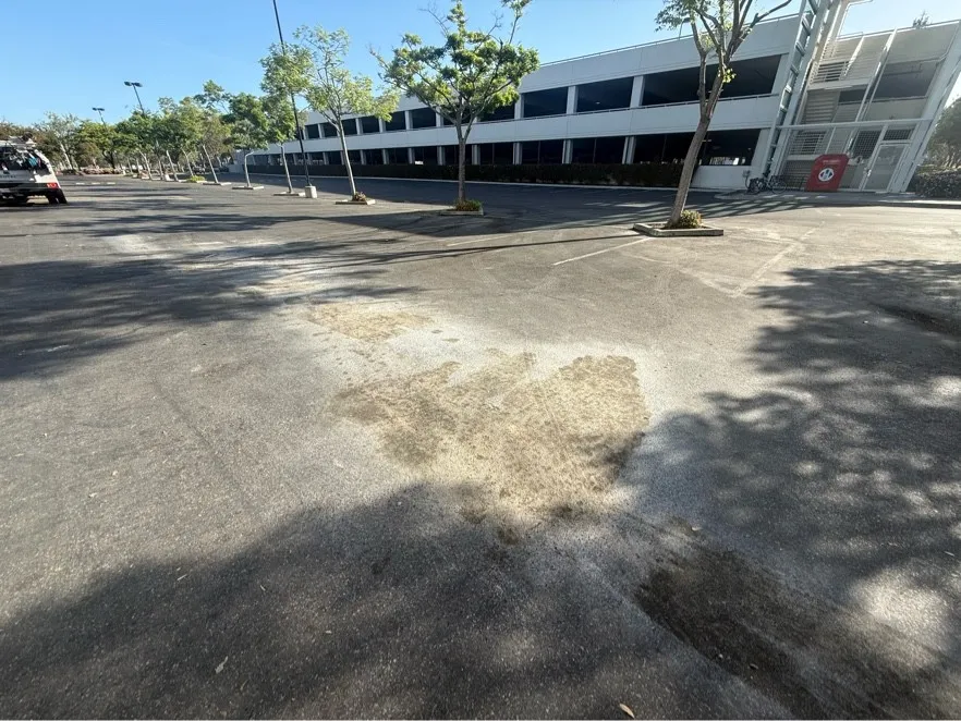 Diesel spill staining an asphalt parking lot before cleanup