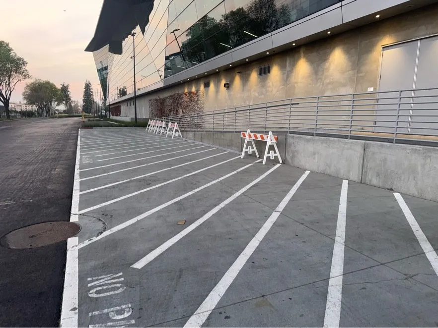 Parking area beside a corporate building after hot-water pressure washing