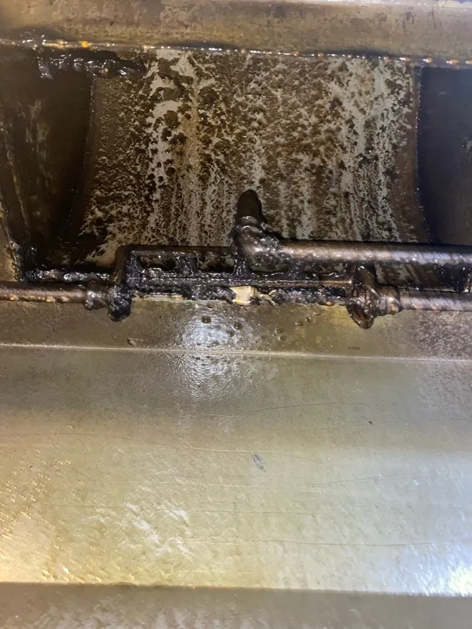 Grease buildup in a hood plenum before cleaning