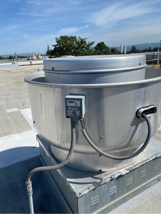Upblast kitchen exhaust fan on a rooftop after cleaning