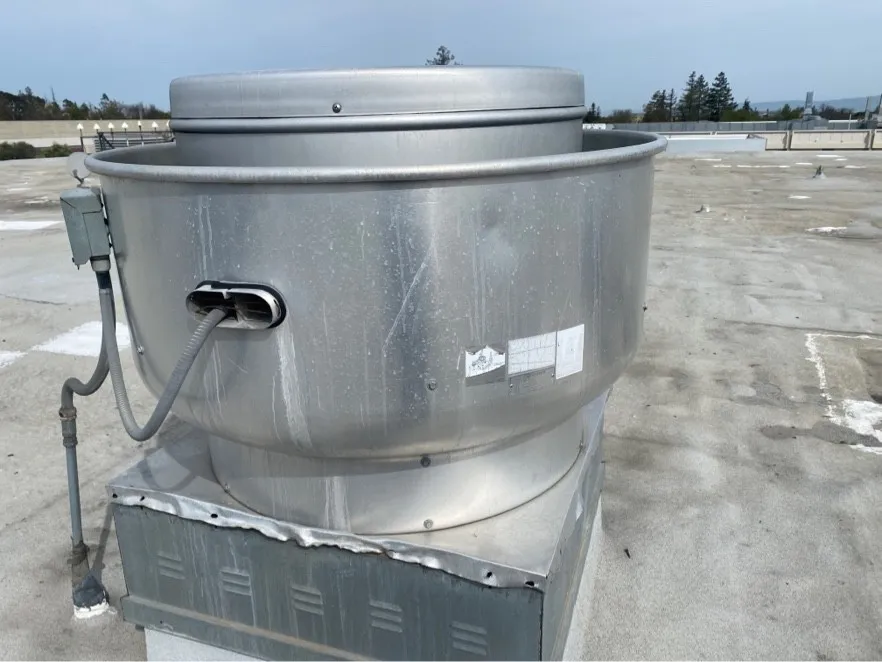 Upblast exhaust fan on a commercial roof after cleaning