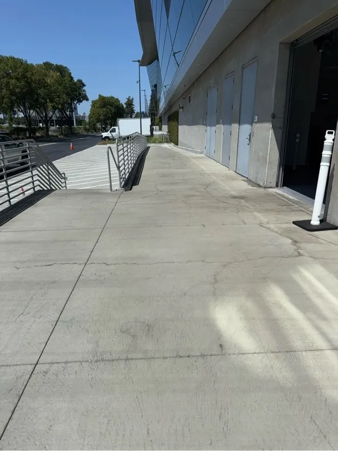 Concrete walkway beside an office building after pressure washing